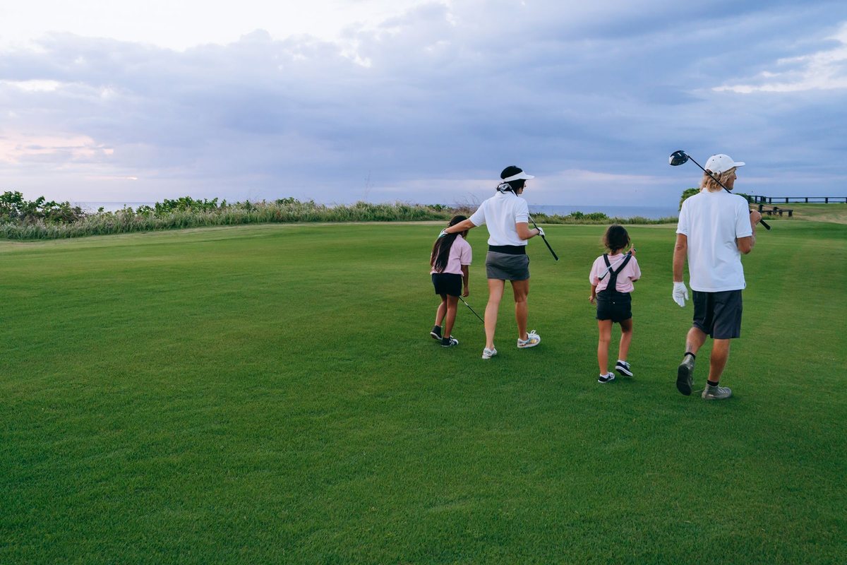 Family walking the fairway at dusk — Morgan Creek golf community living